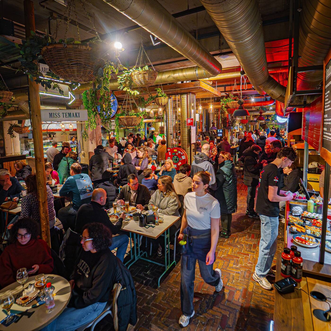 Guests ordering from multiple kitchens at a food court running on Butlaroo.